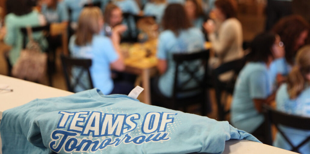 A blue t-shirt and people eating.