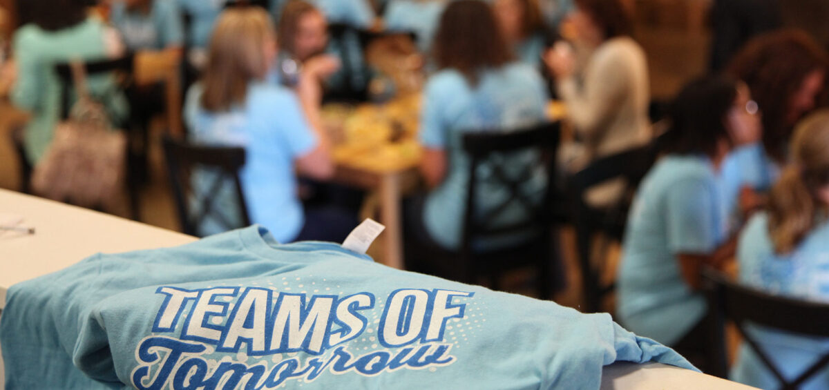 A blue t-shirt and people eating.